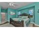 Comfortable main bedroom featuring en-suite bathroom, television and natural light from a double set of windows at 1499 Nuremberg Blvd, Punta Gorda, FL 33983