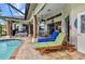 Covered patio features an in-ground pool, outdoor lounge seating and a ceiling fan at 1499 Nuremberg Blvd, Punta Gorda, FL 33983