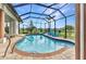 Inviting screened pool features a brick paver surround, in-ground pool, and an outdoor lounge area at 1499 Nuremberg Blvd, Punta Gorda, FL 33983