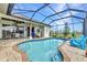 Inviting screened pool features a brick paver surround, in-ground pool, and an outdoor lounge area at 1499 Nuremberg Blvd, Punta Gorda, FL 33983