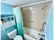 Functional bathroom with blue walls, a shower/tub combination, safety bars, and a small shelf at 1515 Forrest Nelson Blvd # D102, Port Charlotte, FL 33952