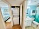 A bathroom with blue walls and a white vanity featuring a modern, clean design at 1515 Forrest Nelson Blvd # D102, Port Charlotte, FL 33952