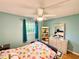 Bedroom boasts light blue walls, wooden floors, and decor accents for a comfy living space at 1515 Forrest Nelson Blvd # D102, Port Charlotte, FL 33952