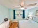 Bedroom featuring wood floors, ceiling fan and light blue walls at 1515 Forrest Nelson Blvd # D102, Port Charlotte, FL 33952