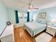 Bedroom featuring wood floors, ceiling fan and light blue walls at 1515 Forrest Nelson Blvd # D102, Port Charlotte, FL 33952