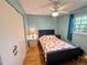 Bright bedroom with wooden floors, ceiling fan, a floral comforter and a closet at 1515 Forrest Nelson Blvd # D102, Port Charlotte, FL 33952