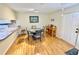 Dining area with a round table, hardwood floors, and open access to the kitchen, ideal for Gathering meals at 1515 Forrest Nelson Blvd # D102, Port Charlotte, FL 33952