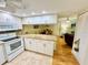 Bright kitchen with white cabinets, granite countertops, and tile floors, offering a clean and modern design at 1515 Forrest Nelson Blvd # D102, Port Charlotte, FL 33952