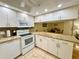 Kitchen with white appliances, granite counters and eating area at 1515 Forrest Nelson Blvd # D102, Port Charlotte, FL 33952