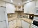 Bright kitchen with white cabinets, stainless sink and granite countertops at 1515 Forrest Nelson Blvd # D102, Port Charlotte, FL 33952