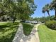 Scenic walkways, palm trees and shade trees provide a park-like feel to the community parking area at 1515 Forrest Nelson Blvd # D102, Port Charlotte, FL 33952