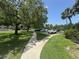 Manicured lawns and mature trees surround the parking area in this well-maintained community at 1515 Forrest Nelson Blvd # D102, Port Charlotte, FL 33952