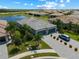 Aerial view of home, highlighting the spacious lot, paver driveway, three-car garage, and proximity to a serene lake at 15974 Clear Skies Pl, Bradenton, FL 34211