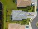 Aerial shot of home and neighborhood with gray roof, fenced in backyard, pond, and car in driveway at 15974 Clear Skies Pl, Bradenton, FL 34211