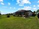 Well-maintained backyard with privacy fence, lush lawn and covered patio at 15974 Clear Skies Pl, Bradenton, FL 34211