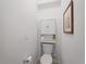 Bathroom featuring a toilet with a built-in cabinet and storage shelves at 15974 Clear Skies Pl, Bradenton, FL 34211