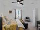 Bright bedroom featuring a ceiling fan, large window, and a comfortable seating area at 15974 Clear Skies Pl, Bradenton, FL 34211