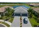 Beautiful home with a well-manicured lawn, paver driveway, tile roof and pond view at 15974 Clear Skies Pl, Bradenton, FL 34211