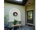 Front entrance with a gray door, decorative niche and small potted plants at 15974 Clear Skies Pl, Bradenton, FL 34211