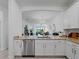 Kitchen view to living room with modern appliances and white cabinets at 15974 Clear Skies Pl, Bradenton, FL 34211