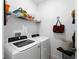 Bright laundry room with washer, dryer and shelf space for convenient storage at 15974 Clear Skies Pl, Bradenton, FL 34211