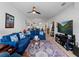 Bright living room with a comfortable blue sofa, stylish decor, and view into kitchen at 15974 Clear Skies Pl, Bradenton, FL 34211