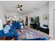 Bright living room with a comfortable blue sofa, stylish decor, and view into kitchen at 15974 Clear Skies Pl, Bradenton, FL 34211