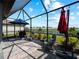 Inviting patio with view of fenced-in lawn and lake at 15974 Clear Skies Pl, Bradenton, FL 34211