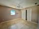 Bedroom features white tile floors, ceiling fan and closet at 1611 Robbins Rd, Nokomis, FL 34275