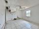 Bedroom with damaged ceiling, tile floors, and natural light at 1611 Robbins Rd, Nokomis, FL 34275