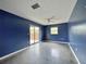 Bedroom with polished concrete floor, and sliding glass door to backyard at 1611 Robbins Rd, Nokomis, FL 34275