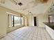 Bright dining room features white tile floors, a large window and closet, creating an inviting space at 1611 Robbins Rd, Nokomis, FL 34275