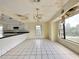 Bright dining room features white tile floors, and kitchen access, creating an inviting space for meals and gatherings at 1611 Robbins Rd, Nokomis, FL 34275