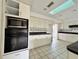 Kitchen featuring white cabinets, stainless steel appliances, and tile flooring at 1611 Robbins Rd, Nokomis, FL 34275