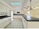Well-lit kitchen featuring ample cabinetry and counter space at 1611 Robbins Rd, Nokomis, FL 34275