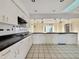 Bright kitchen featuring white cabinetry, a black countertop, and modern appliances at 1611 Robbins Rd, Nokomis, FL 34275