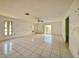 Spacious living room features white tile floors and a ceiling fan at 1611 Robbins Rd, Nokomis, FL 34275
