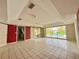 Spacious living room with tile flooring, large windows, and access to kitchen at 1611 Robbins Rd, Nokomis, FL 34275