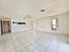 Open living room with white tile floors, ceiling fan and multiple windows at 1611 Robbins Rd, Nokomis, FL 34275