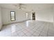 Bright living room with tile flooring, windows, and ceiling fan at 1611 Robbins Rd, Nokomis, FL 34275