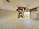 Spacious living room with a fireplace, tile flooring, and natural light at 1611 Robbins Rd, Nokomis, FL 34275