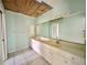 Bathroom boasts a dual sink vanity, large mirror, and ample cabinet space at 1611 Robbins Rd, Nokomis, FL 34275