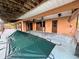 Covered pool area with open beam ceiling and built-in cabinets at 1611 Robbins Rd, Nokomis, FL 34275