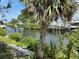 Canal view featuring lush foliage, waterfront access, and residential docks at 1611 Robbins Rd, Nokomis, FL 34275