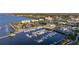 An aerial view shows a marina with boats, a building with a metal roof, and waterfront restaurants at 1801 Los Alamos Dr, Punta Gorda, FL 33950
