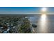A high aerial view shows a cityscape along the water including the Gulf, a pier and waterfront buildings at 1801 Los Alamos Dr, Punta Gorda, FL 33950