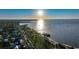 A high aerial view shows a cityscape and the Gulf of Mexico including a long pier and boats on the water at 1801 Los Alamos Dr, Punta Gorda, FL 33950