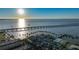 An aerial view of a coastal cityscape featuring the ocean, a bridge, palms and tiki huts on the beach at 1801 Los Alamos Dr, Punta Gorda, FL 33950