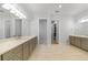 Spacious bathroom with double vanities, and doorway to toilet room and walk-in closet at 1801 Los Alamos Dr, Punta Gorda, FL 33950