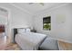 Well-lit bedroom showcases neutral tones, a bed with throw pillows, and wood-look floors at 1801 Los Alamos Dr, Punta Gorda, FL 33950